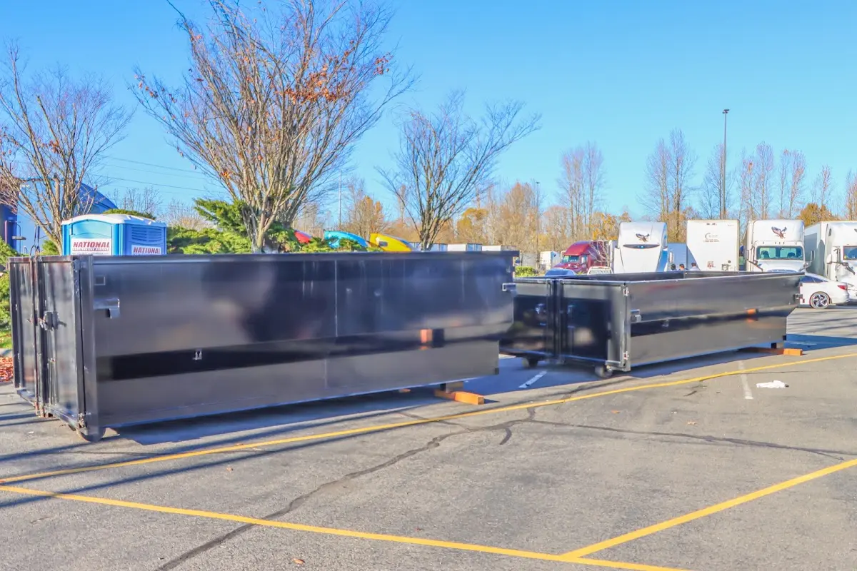 Professional dumpster rental service with roll-off container on residential driveway in Tillmans Corner